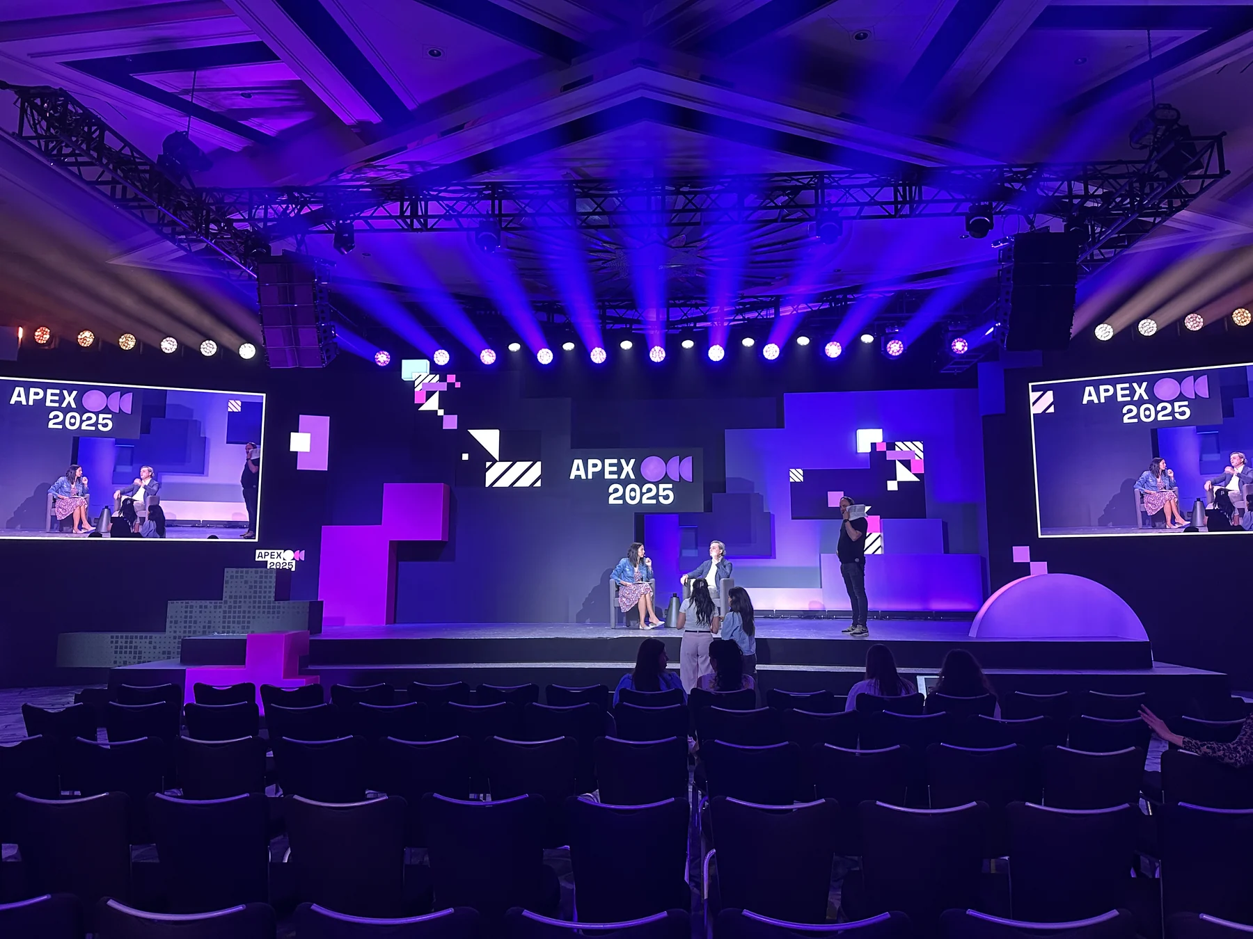 XRP APEX 2025 stage with lighting, screens and audience seating